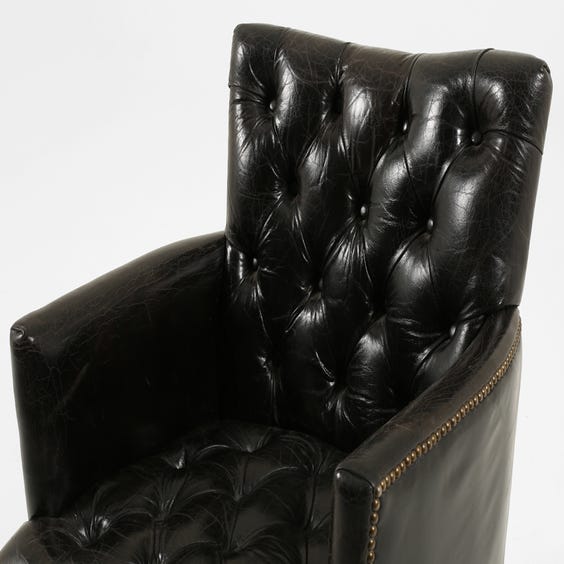 image of Black leather buttoned back armchair