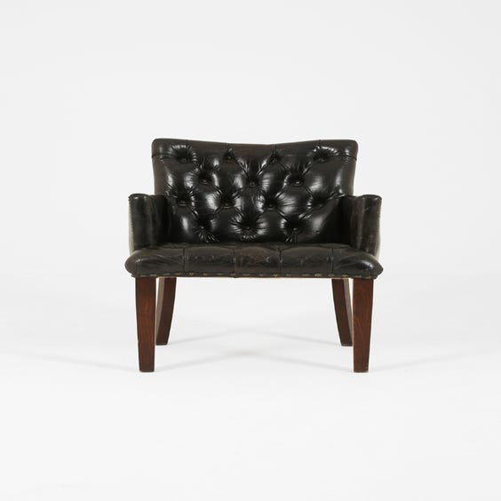 image of Black leather buttoned back armchair