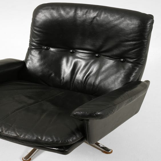 image of Black leather low back armchair