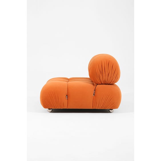 image of 1970s padded pumpkin orange armchair