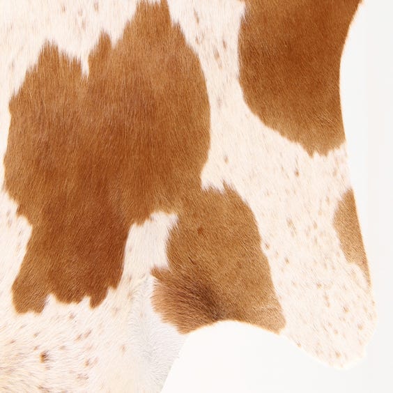 image of Tan and white cow hide rug