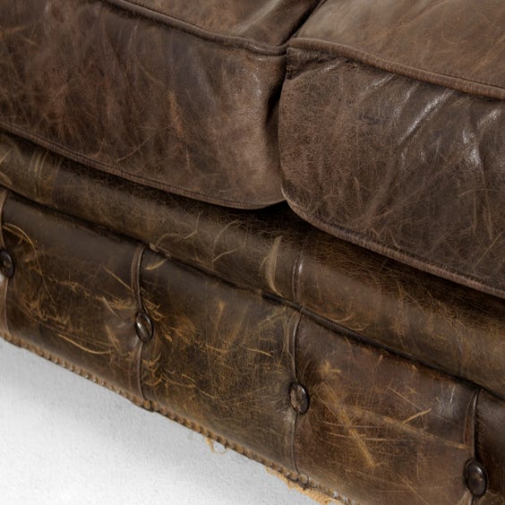 image of Aged black leather Chesterfield sofa