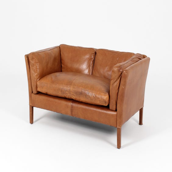 image of Small tan leather sofa