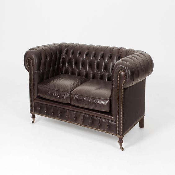image of Black leather chesterfield sofa