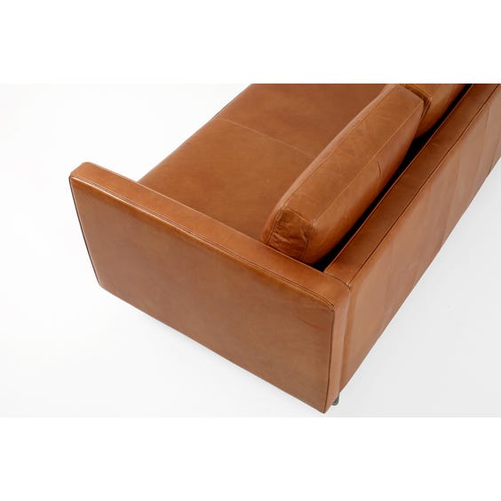 image of Tan leather three seater sofa