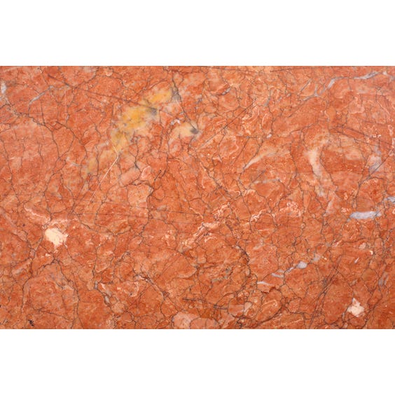 image of Heavily veined pink marble surface