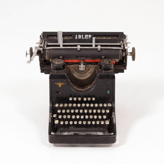 image of Distressed black Adler typewriter
